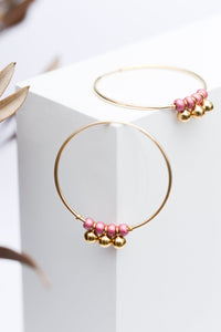 Gold plated drop hoop earrings with pink beads